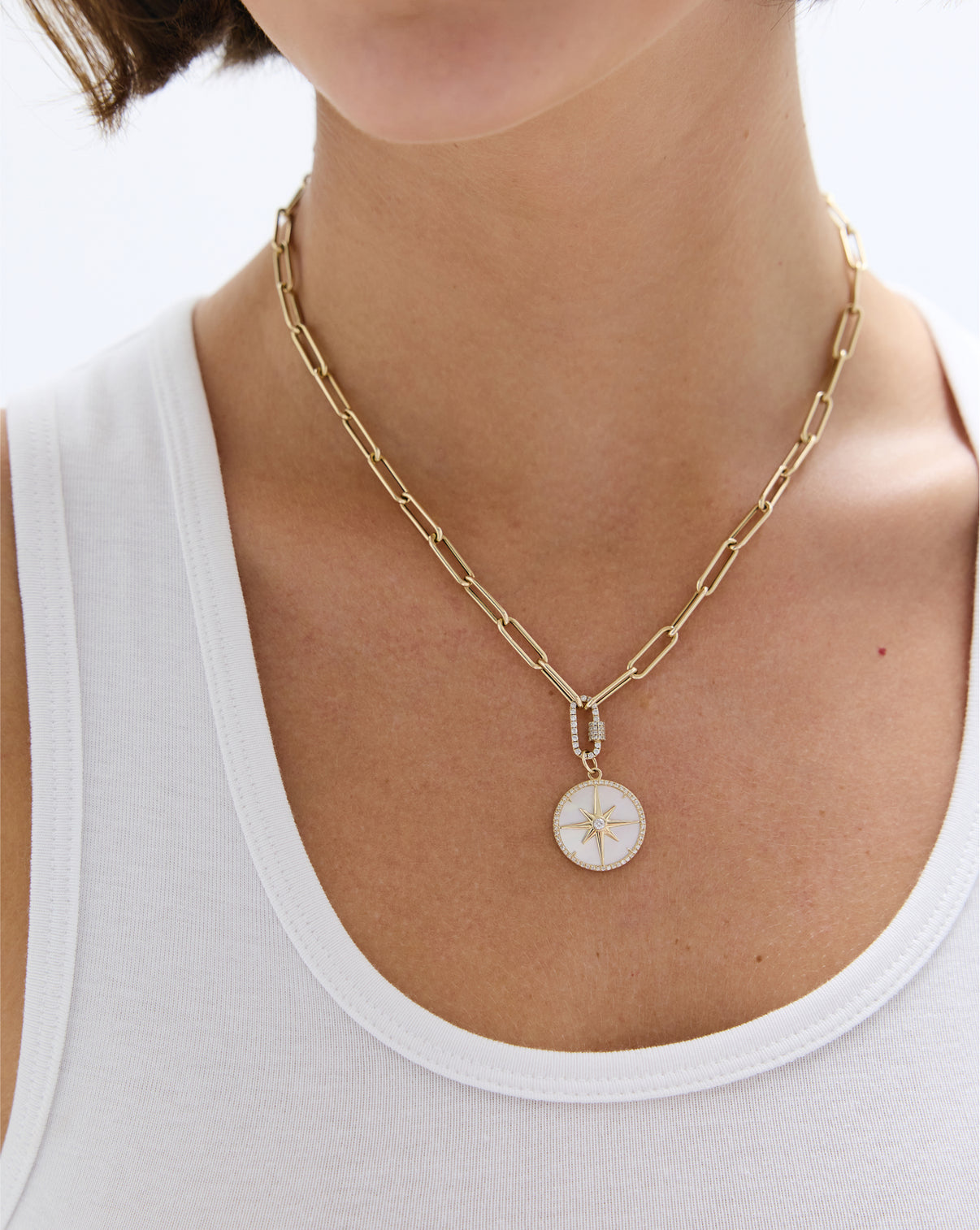 Close-up view of diamond carabiner pendant showcasing diamond details and gold craftsmanship