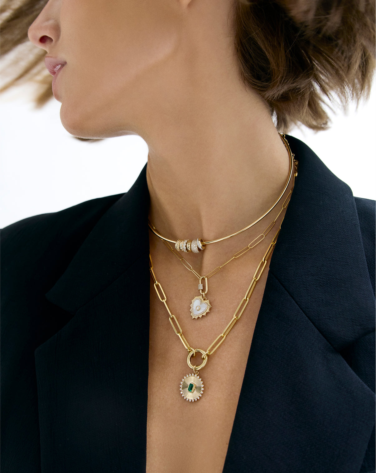 Fluted pearl heart pendant layered with other jewelry pieces, styling shot