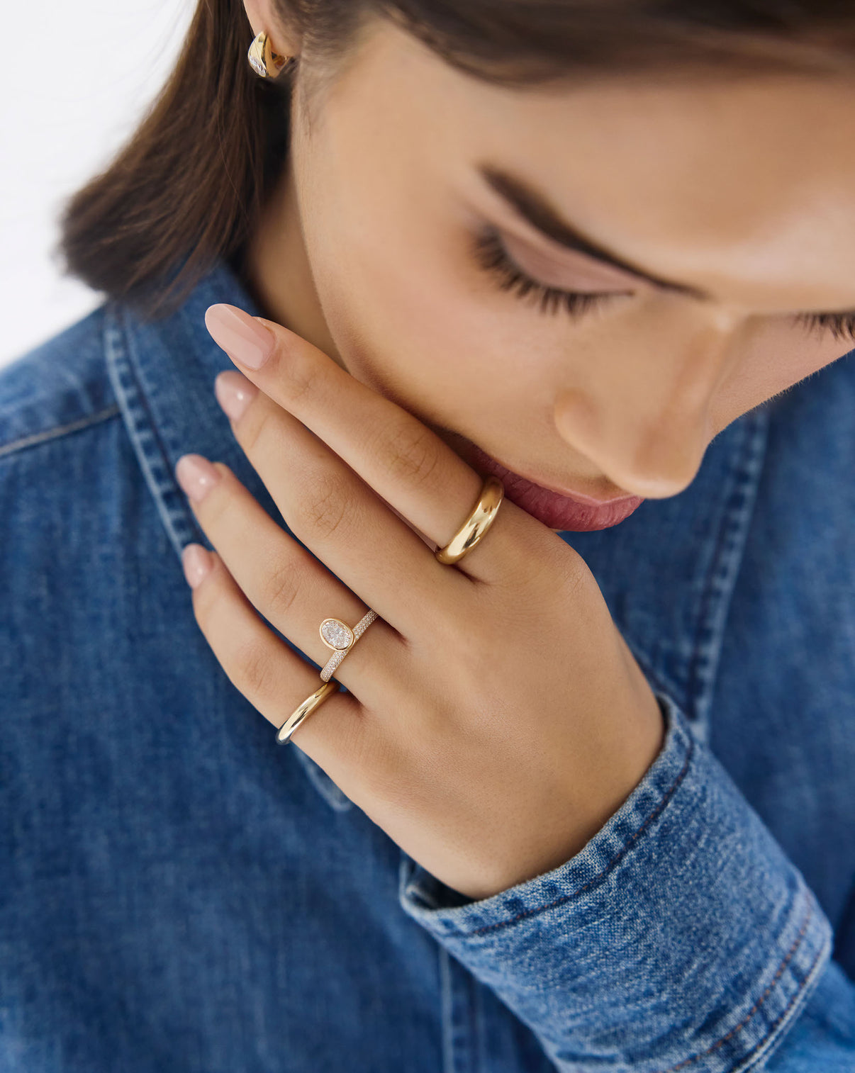 Close-up of model's hand displaying the Gold Cloud Ring's unique sculptural design in 14k yellow gold