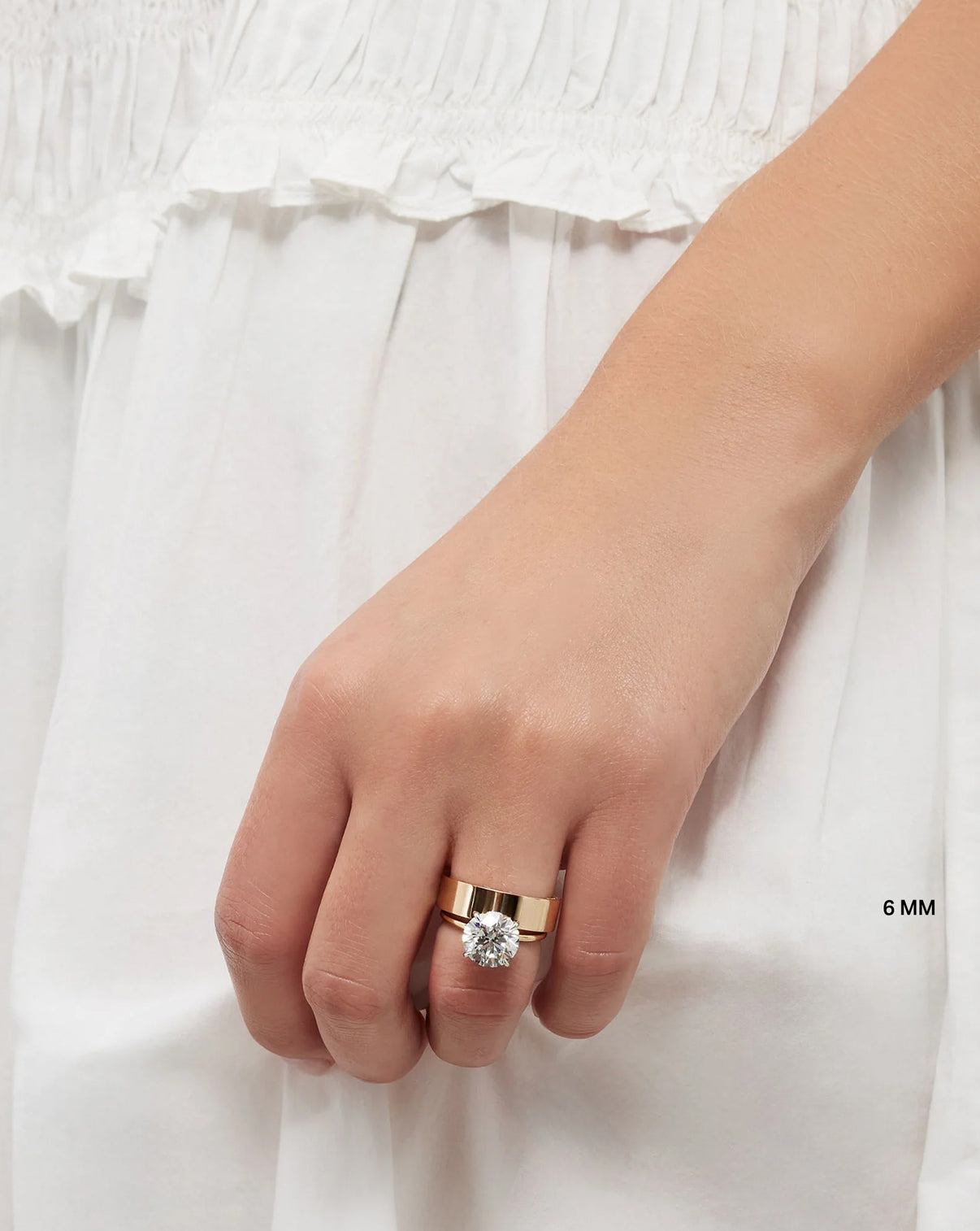 Model wearing brilliant pave cigar band and engagement ring GLOBAL