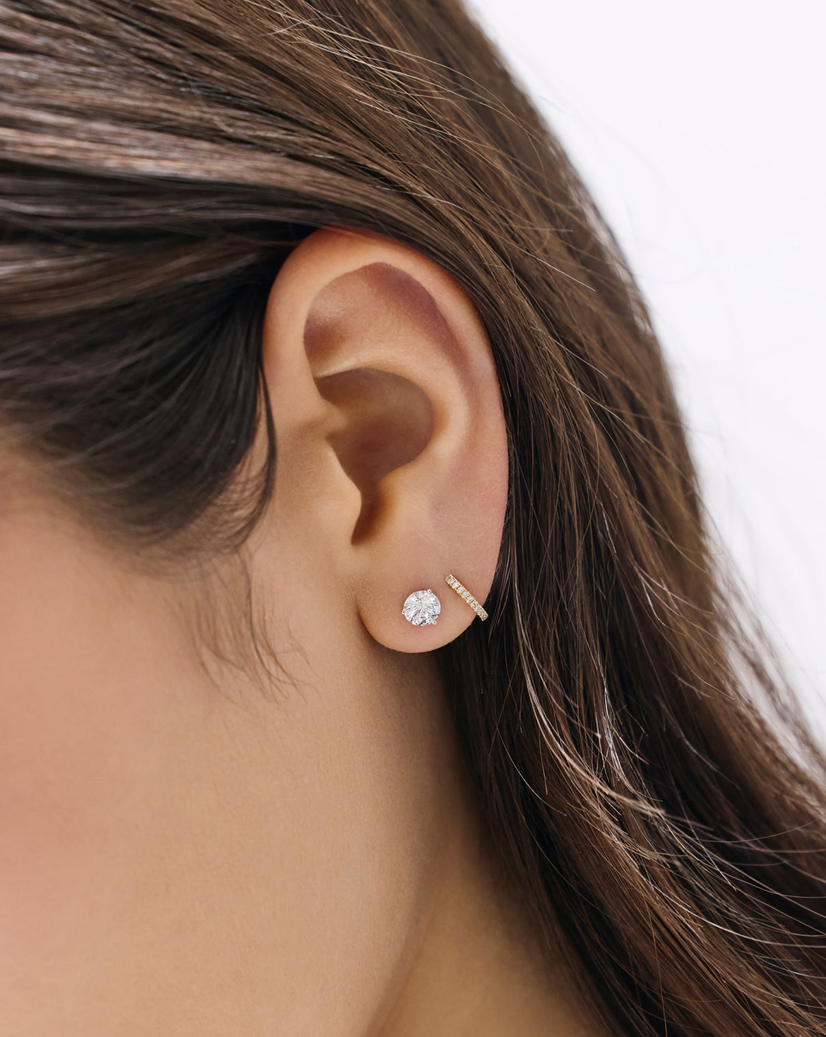 Model wearing Petite Diamond Huggies earrings, showcasing the delicate diamond-set hoop design close to the ear