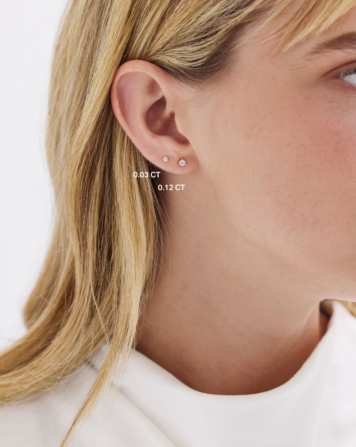 model wearing both sizes of Tiny Diamond Studs