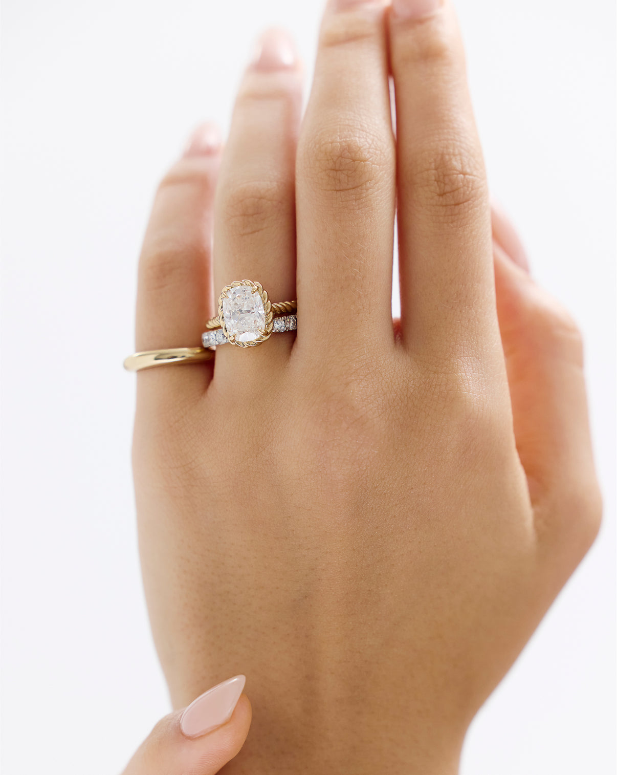 On figure hand of 3.01 Cushion Lab Diamond in Twisted Wrap with eternity band and fine jewelry ring

43126334488664