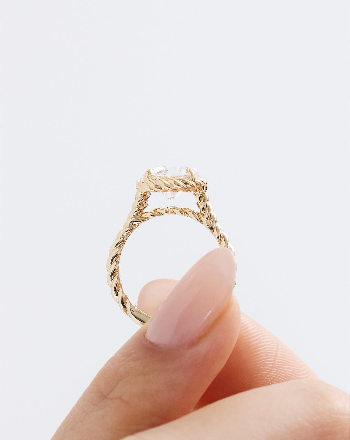 Front view of model holding 3.01 Cushion Lab Diamond in Twisted Wrap

43126334488664