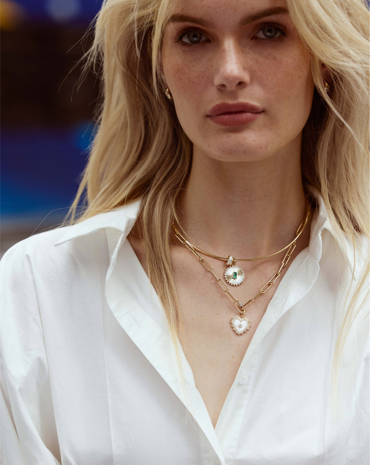 Split chain necklace styled model with heart pendant and gold collar necklace