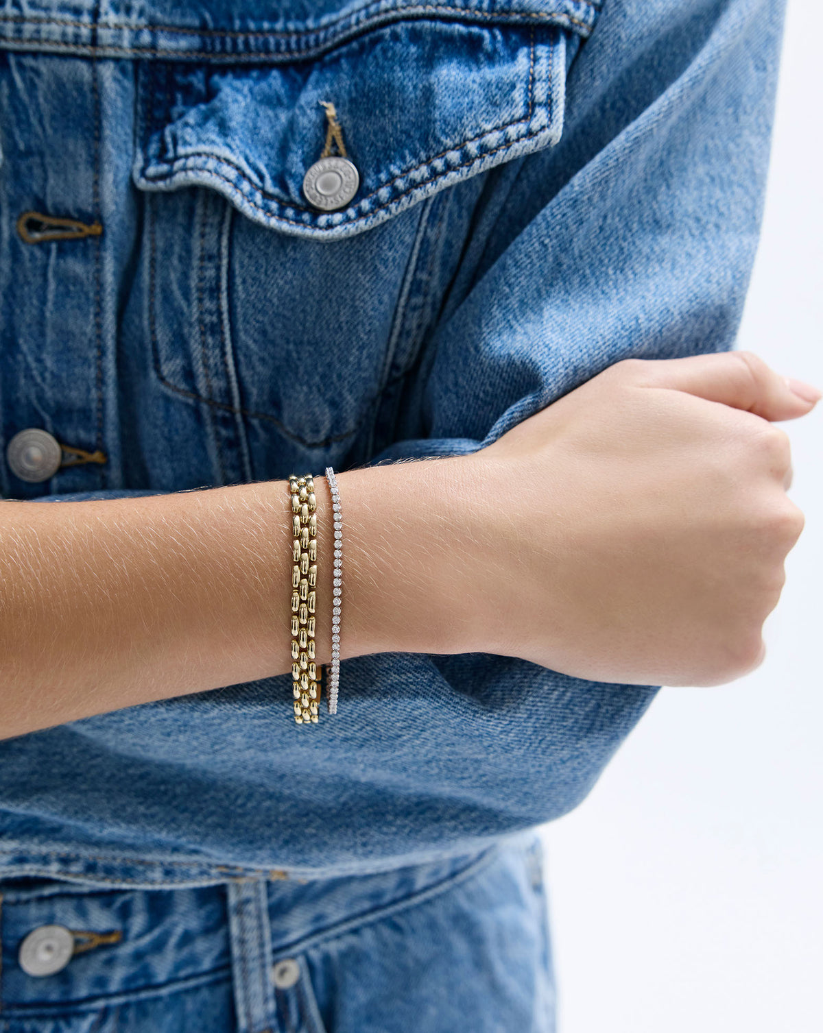 2-in-1 Diamond Tennis Necklace + Bracelet as a bracelet on model styled with chain link bracelet global