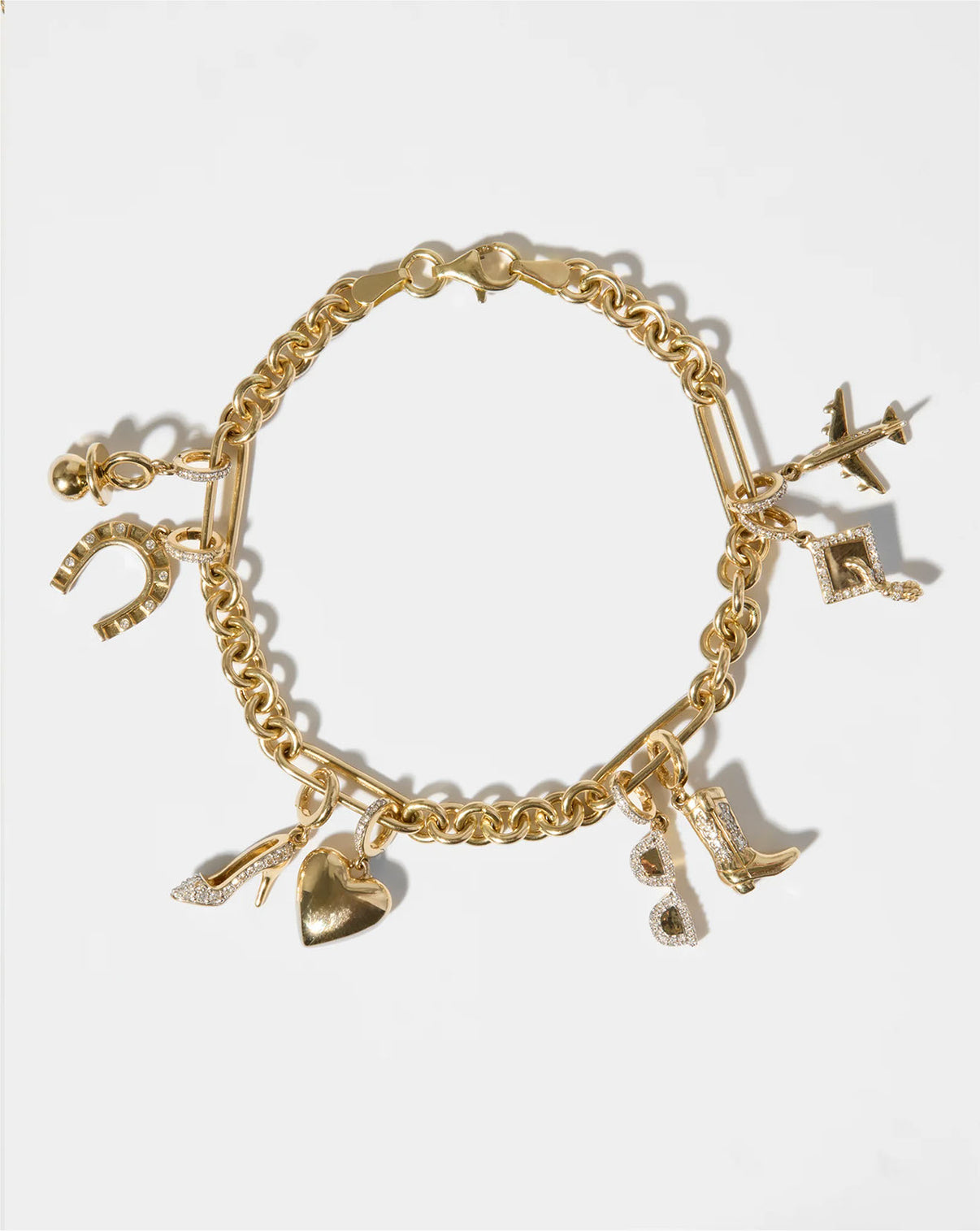 flat lay of gold bracelet with various charms