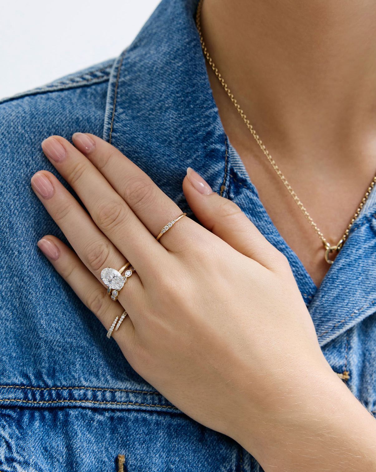 model wearing Diamond Cluster Ring in 14K Yellow Gold styled with other diamond rings