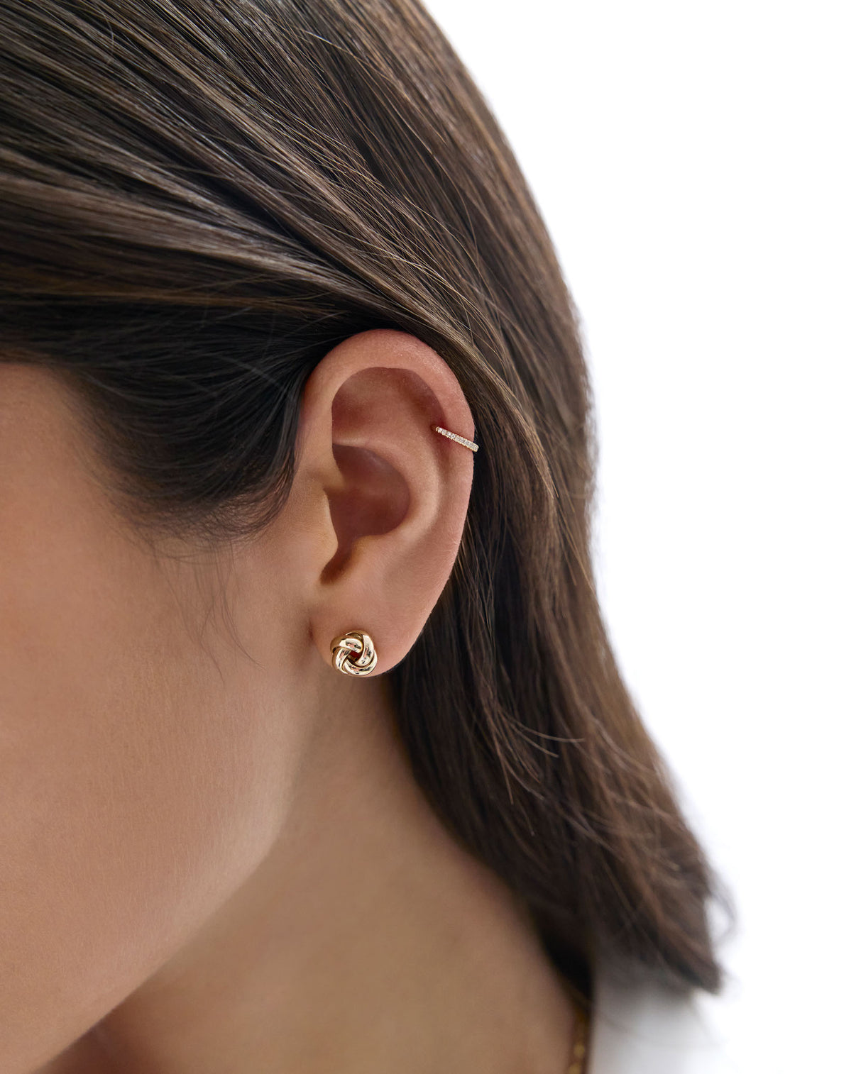 Diamond ear cuff styled with a gold earring on model