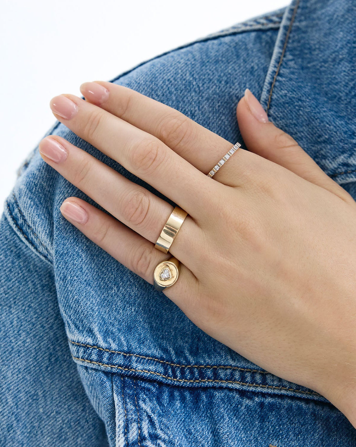 Fluted Diamond Ring stacked on model's finger with fluted ring and other gold rings on hand global