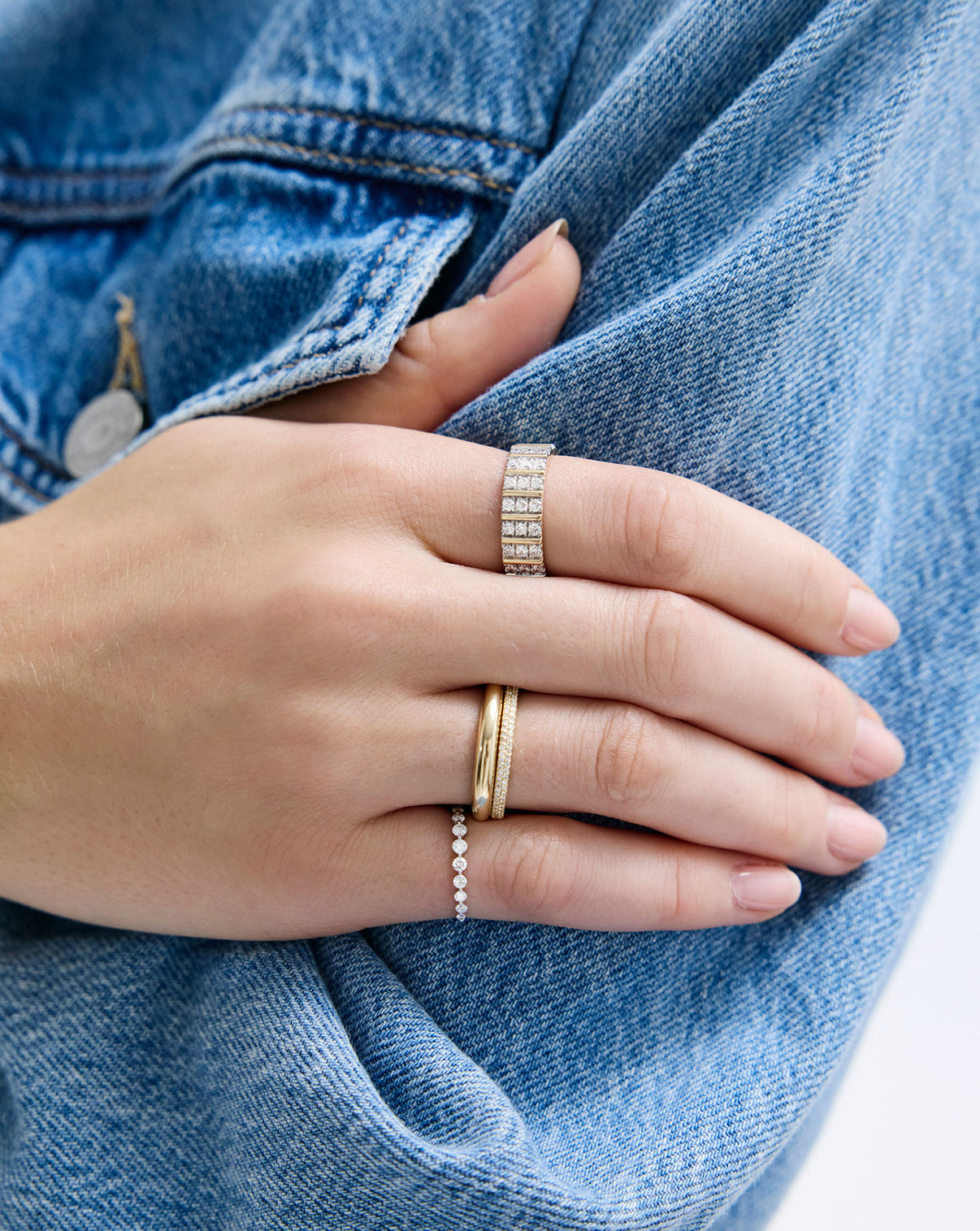 model wearing Three Row Fluted Diamond Ring in styled with other gold rings on hand global