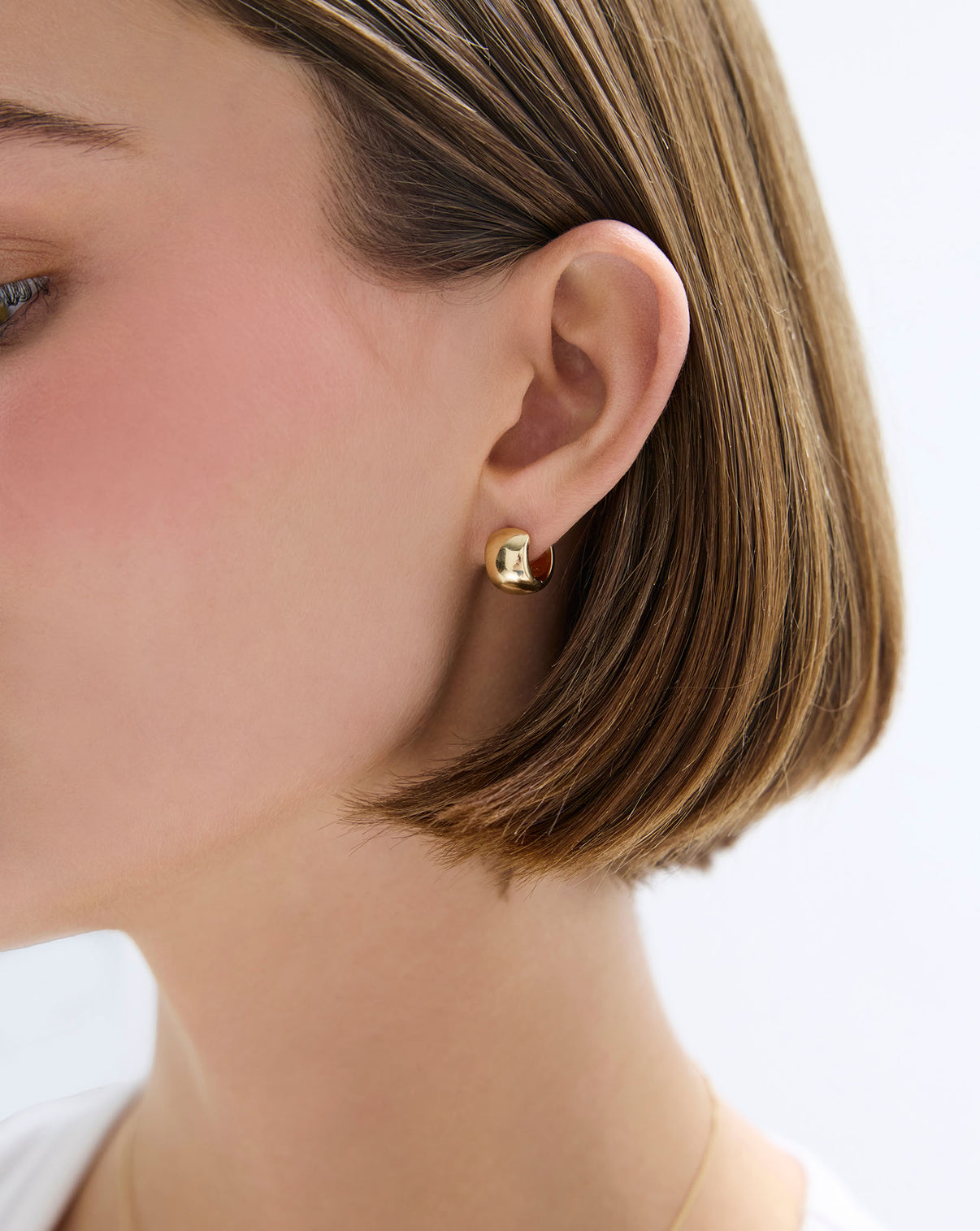 angled shot of Ring Concierge Bold Gold Cloud Huggies 14k Yellow Gold - on-model on the ear