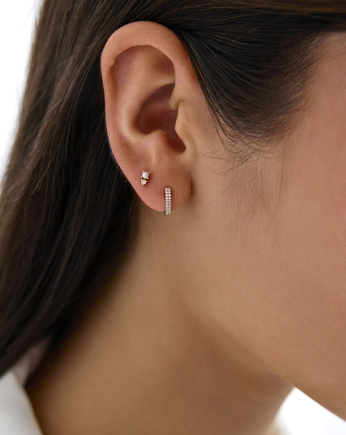 Close up image of the Petite Double Row Huggies shown in ear of model