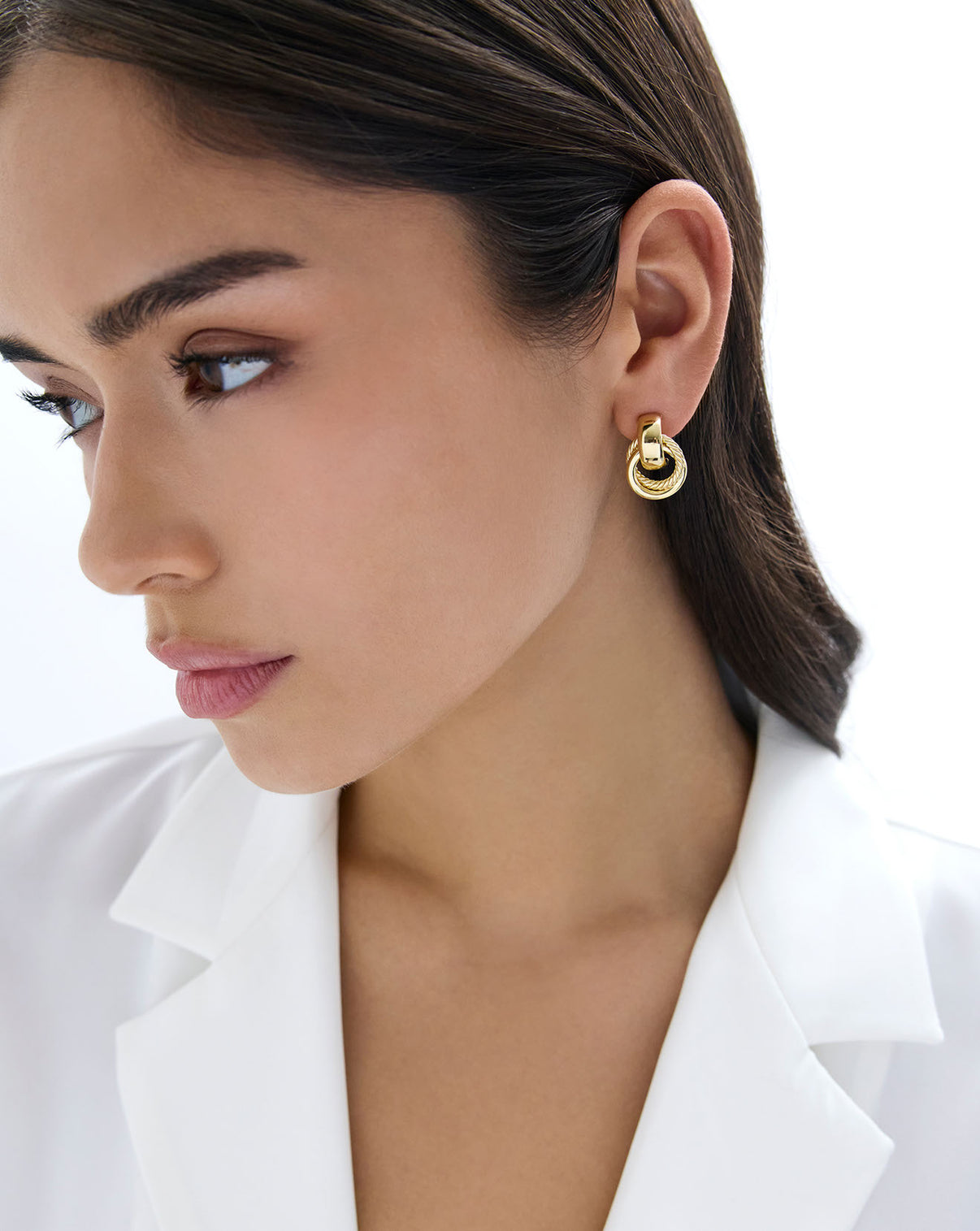 Textured door knocker earrings in yellow gold on-model