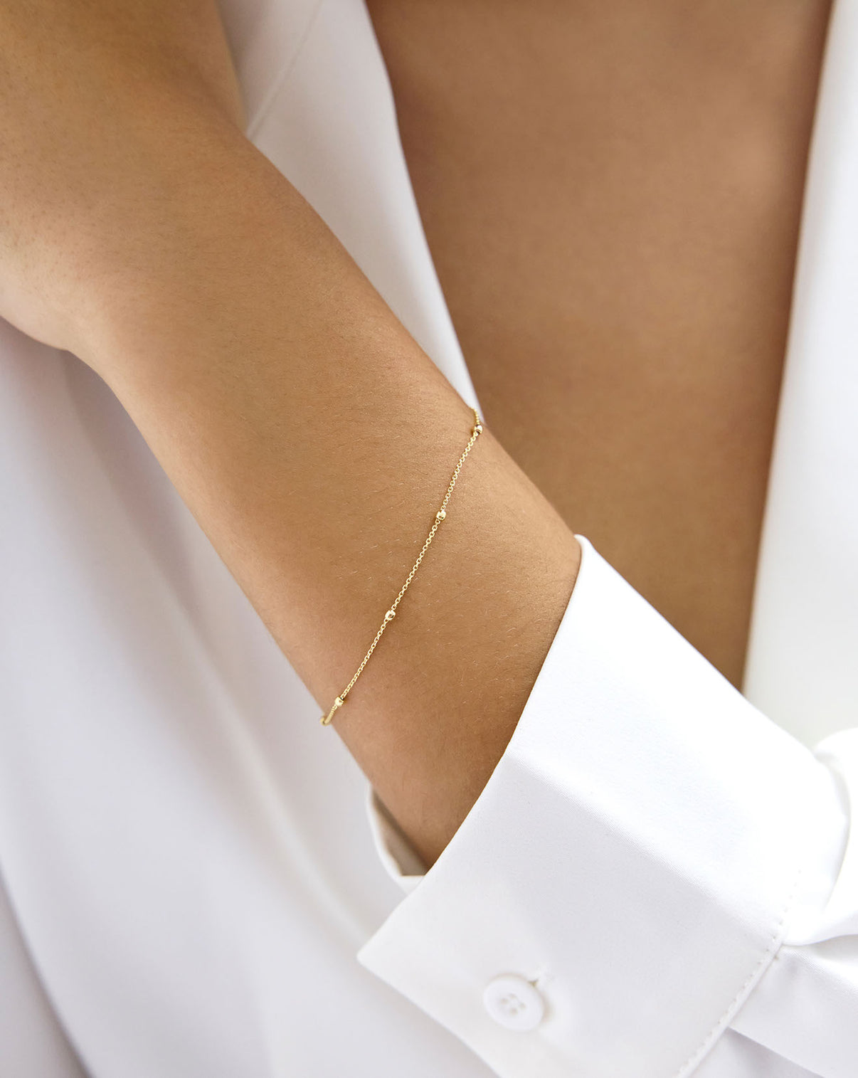 Saturn Chain Bracelet shown around wrist of model