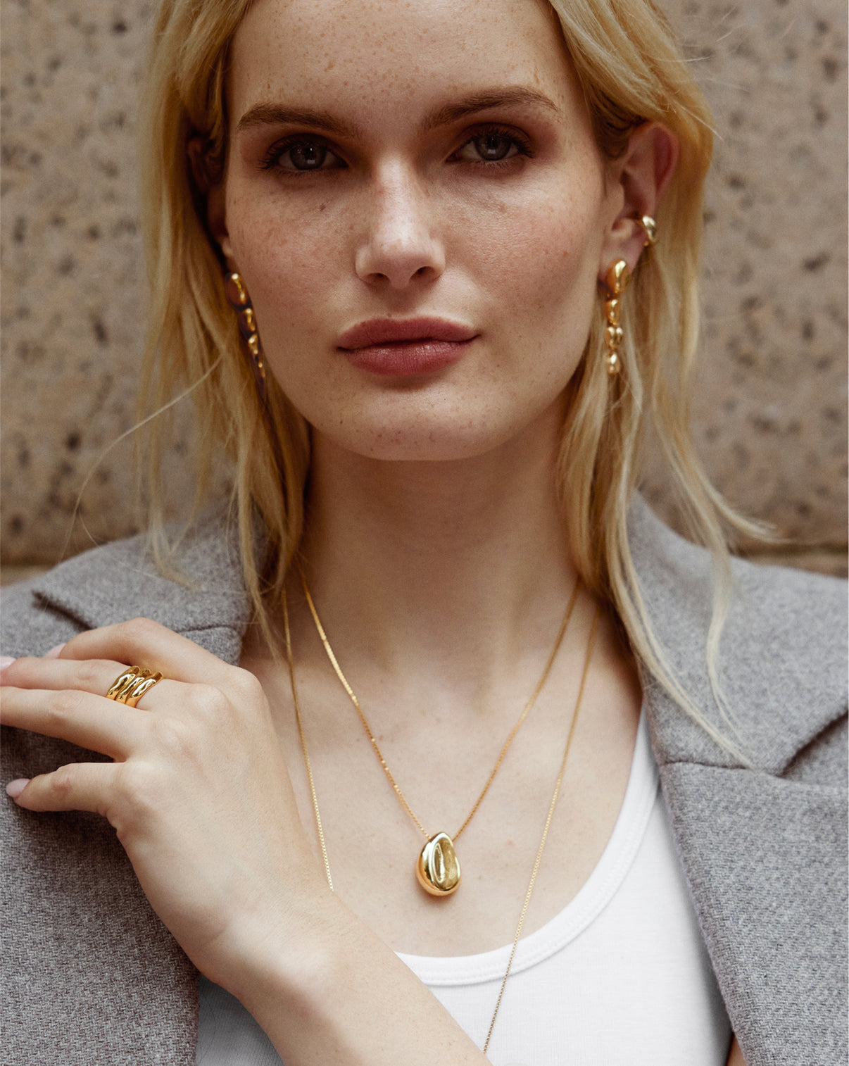 Close-up detail view of the Forma Melted Pendant Necklace showing the intricate geometric design and gold finish"
