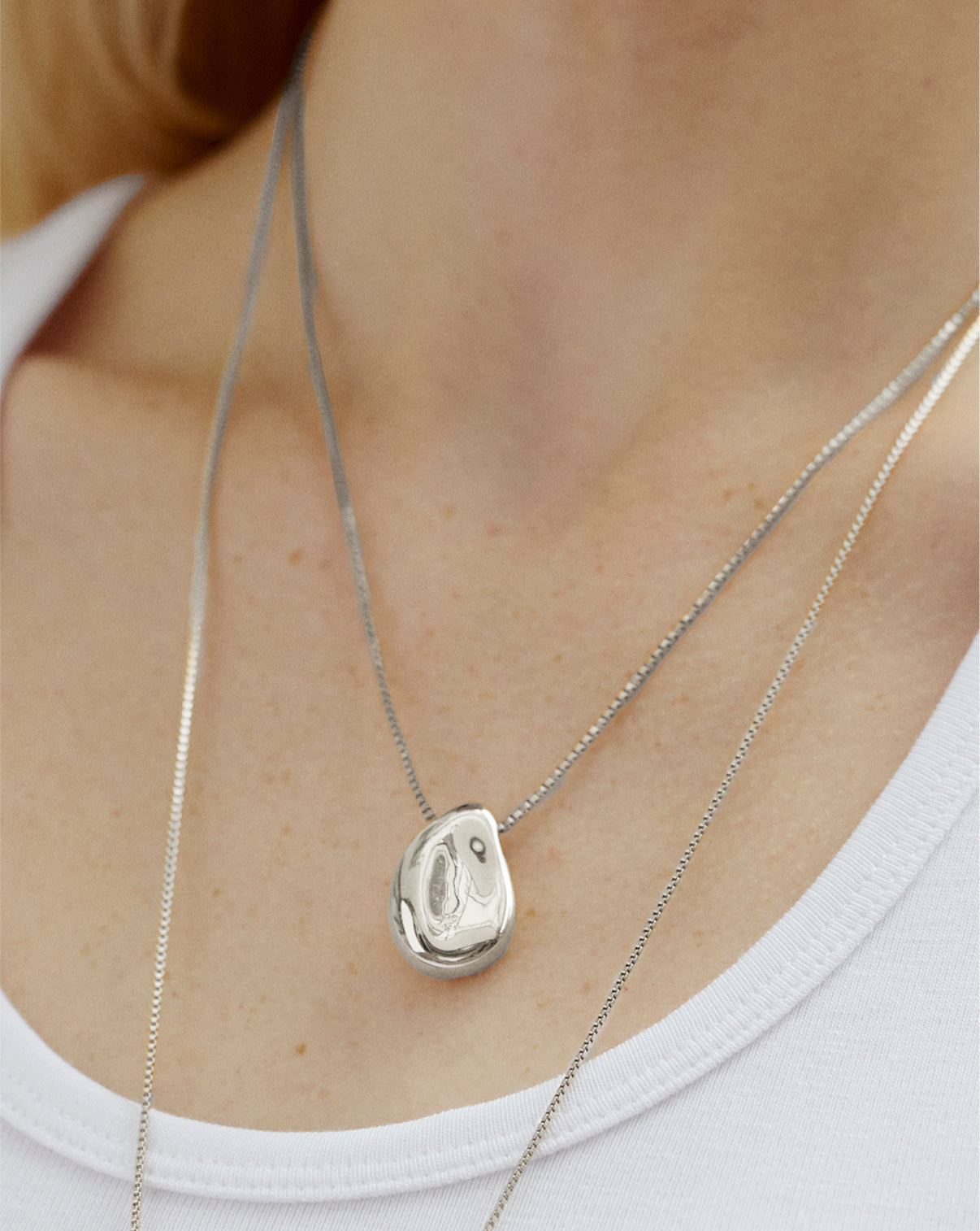 Forma Melted Pendant Necklace styled with other jewelry pieces, demonstrating versatile layering options