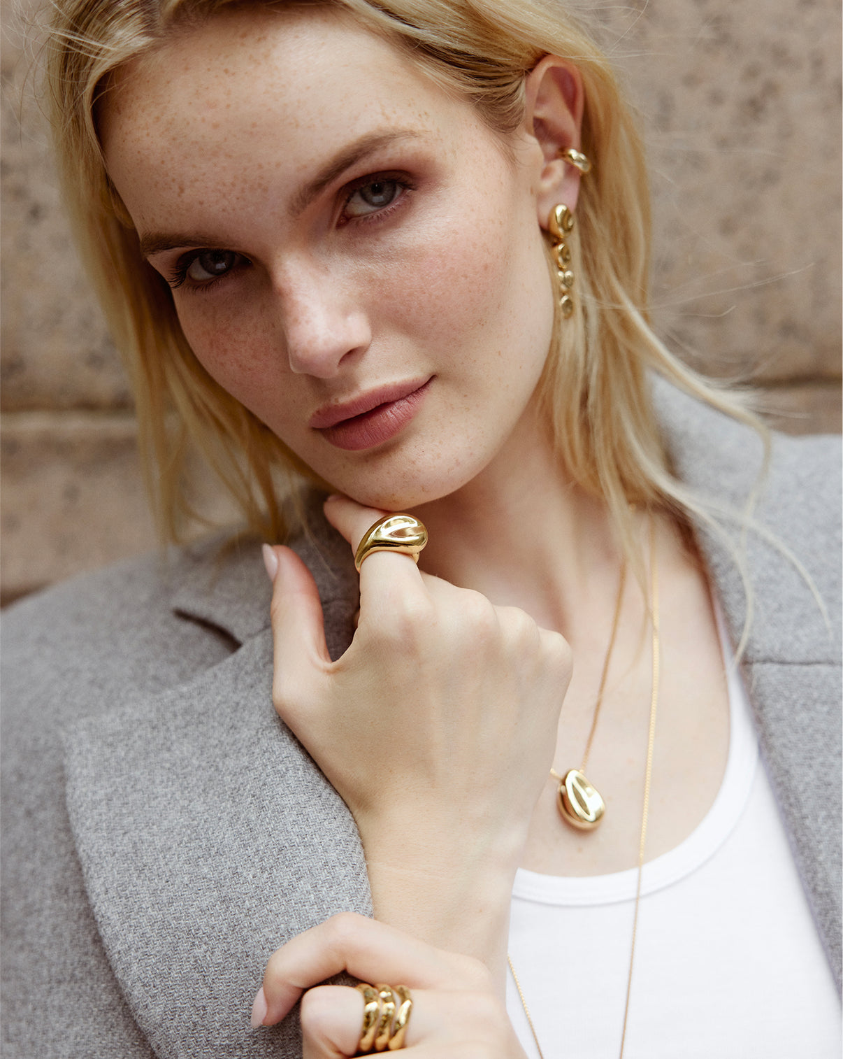 A women showing a close-up view of Melted Pebble Ring showcasing the textured, molten gold surface and artisanal craftsmanship