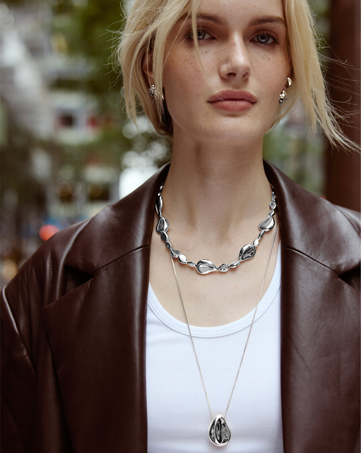 Model wearing the Forma Toggle Clasp Necklace styled highlighting the chain's drape and clasp design