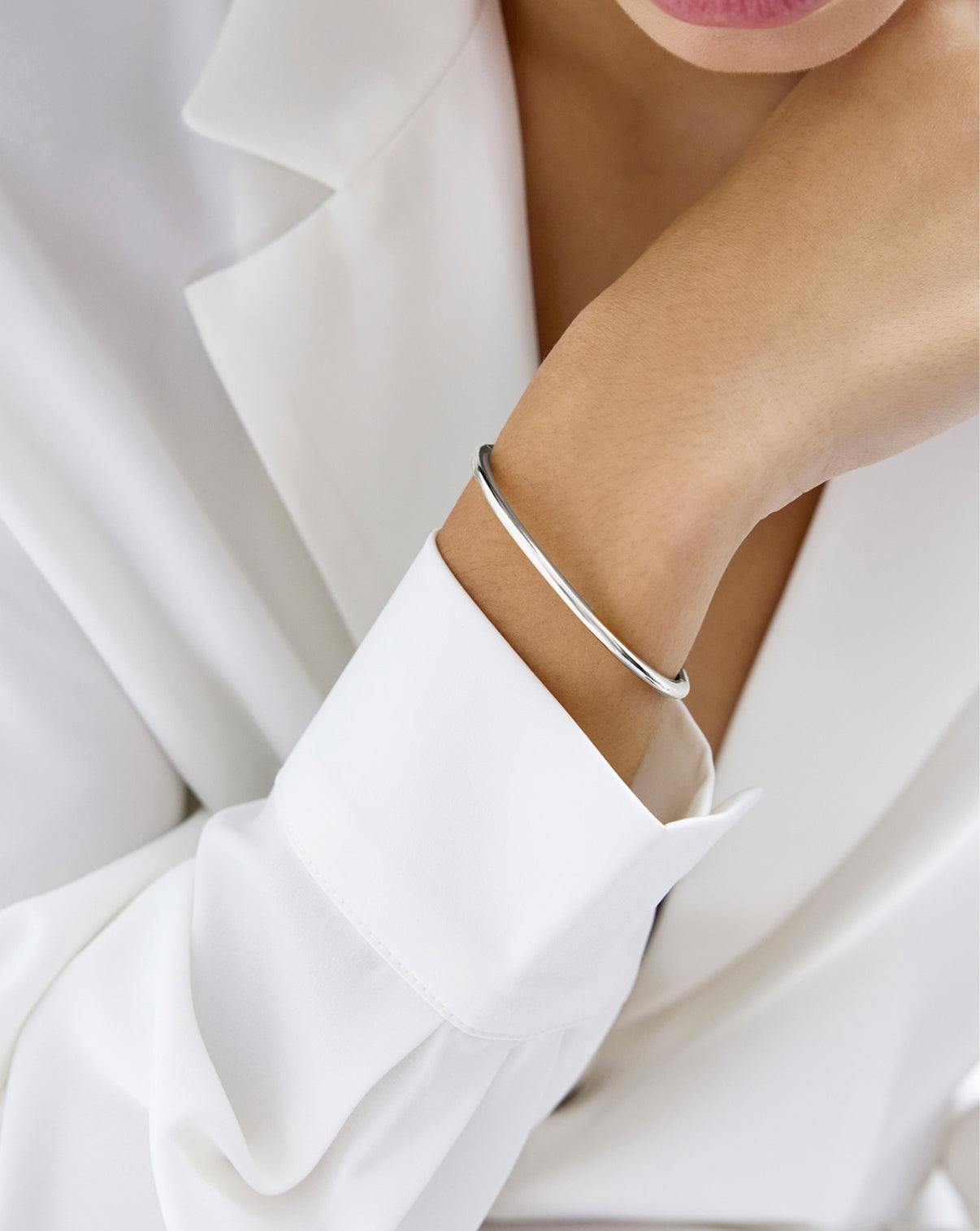 Slim Stackable Cloud Bangle bracelet in 14k white gold shown on model's wrist sterling silver