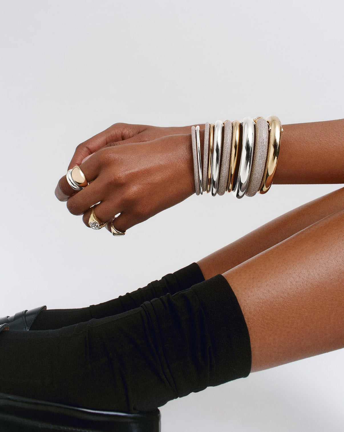 Model wearing our cloud bangles in 14k yellow gold, 14k white gold, sterling silver