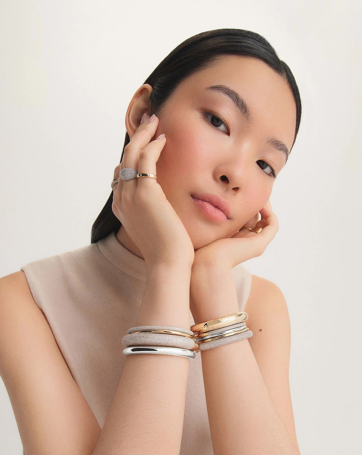 Model wearing different versions of our cloud bangles in 14k yellow gold, 14k white gold, sterling silver