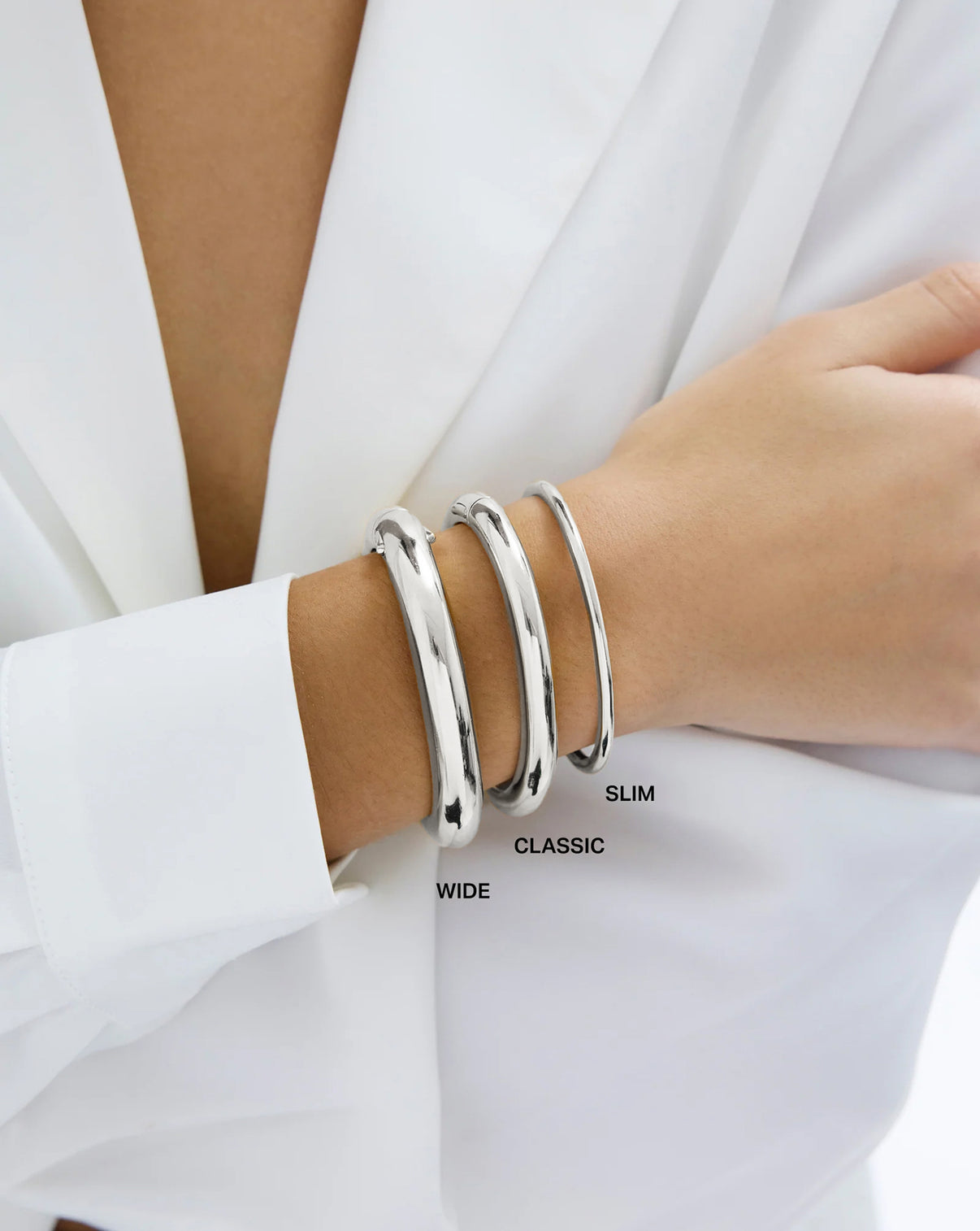 Stackable Cloud Bangle bracelet in 14k white gold and sterling silver shown on model's wrist in all three sizes, slim, classic and wide