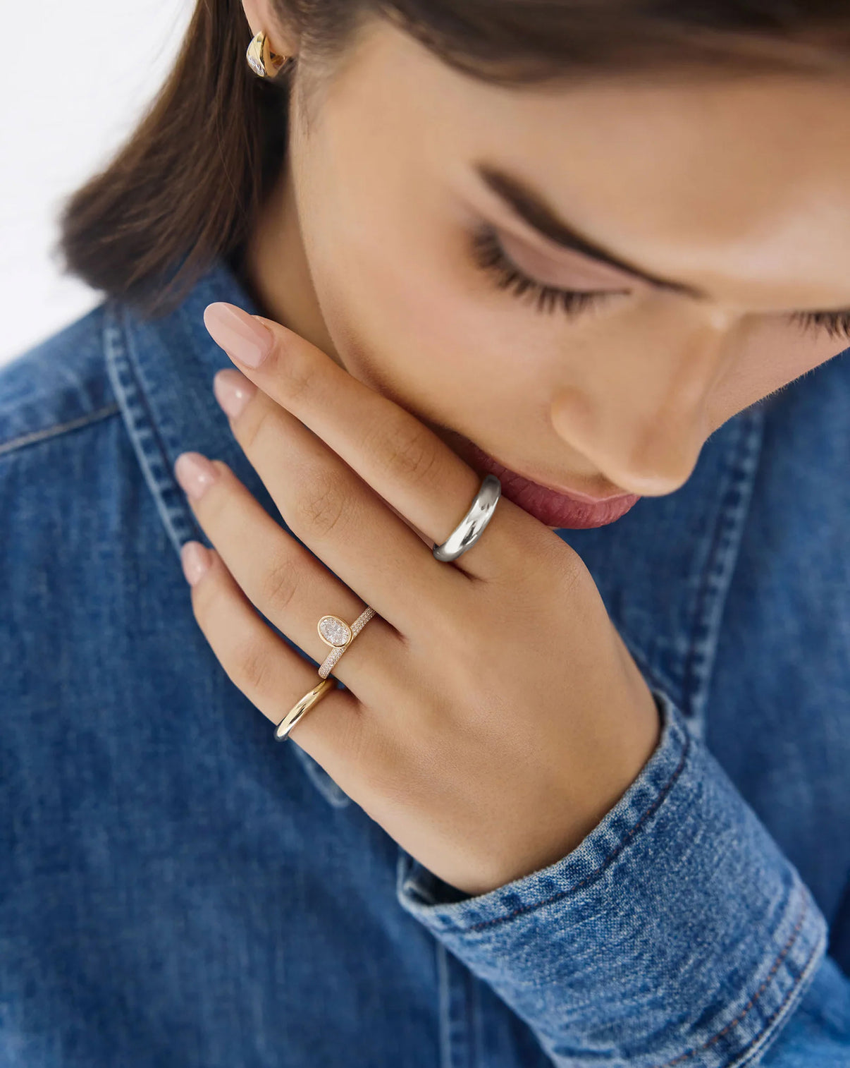 cloud ring in sterling silver shown on model's index finger styled with other gold and diamond rings