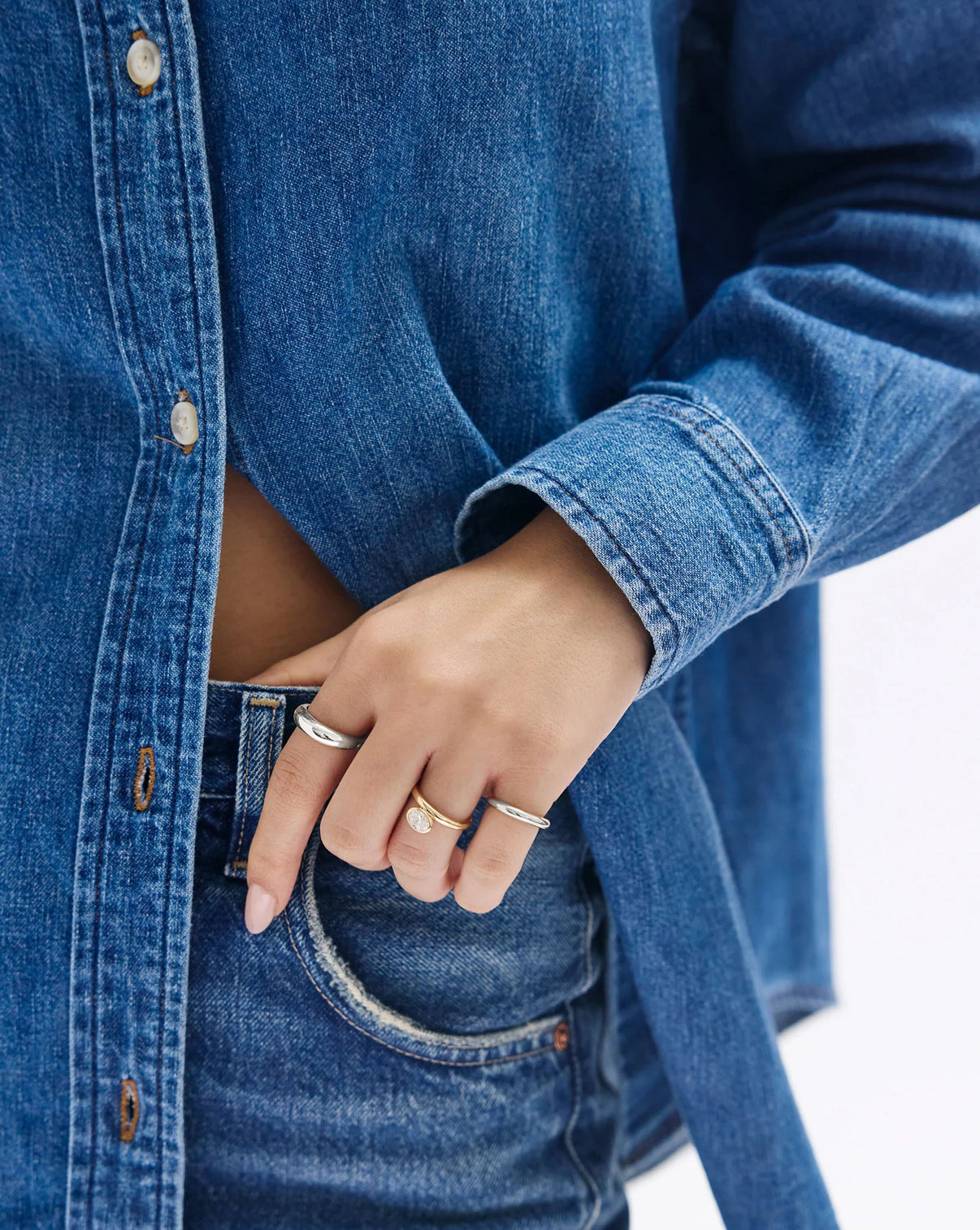 cloud ring in sterling silver worn on model's finger against a denim outfit