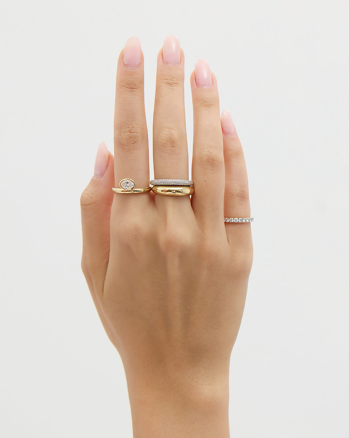 close up of model's hand with Cloud Ring  and various diamond and gold rings