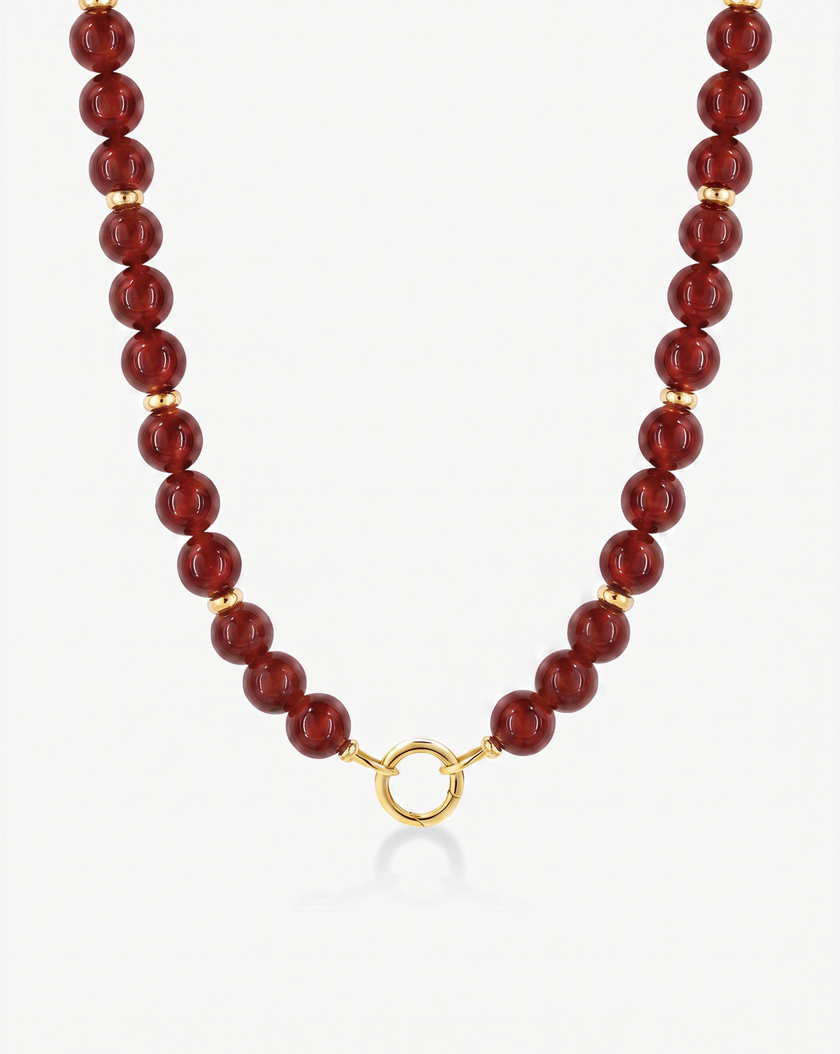 A beaded necklace featuring polished dark red agate beads separated by small gold spacer rings, finished with a gold clasp, shown on a clean white background.