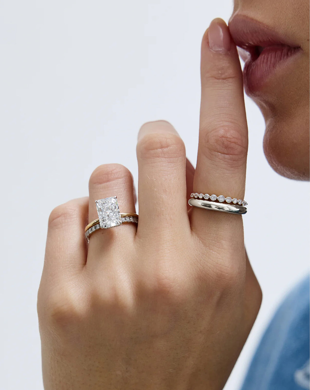 Petite Cloud Ring in sterling silver and 14k white gold worn by model with several other rings