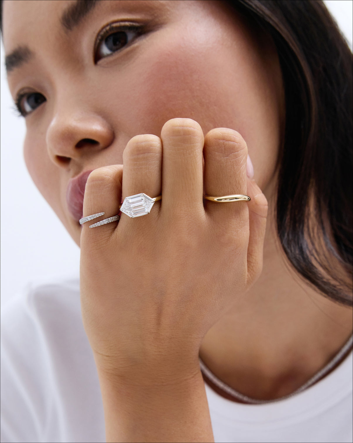 Petite Movement Cloud Ring styled on model's index finger with a diamond engagement ring and open diamond wrap ring
14k yellow gold