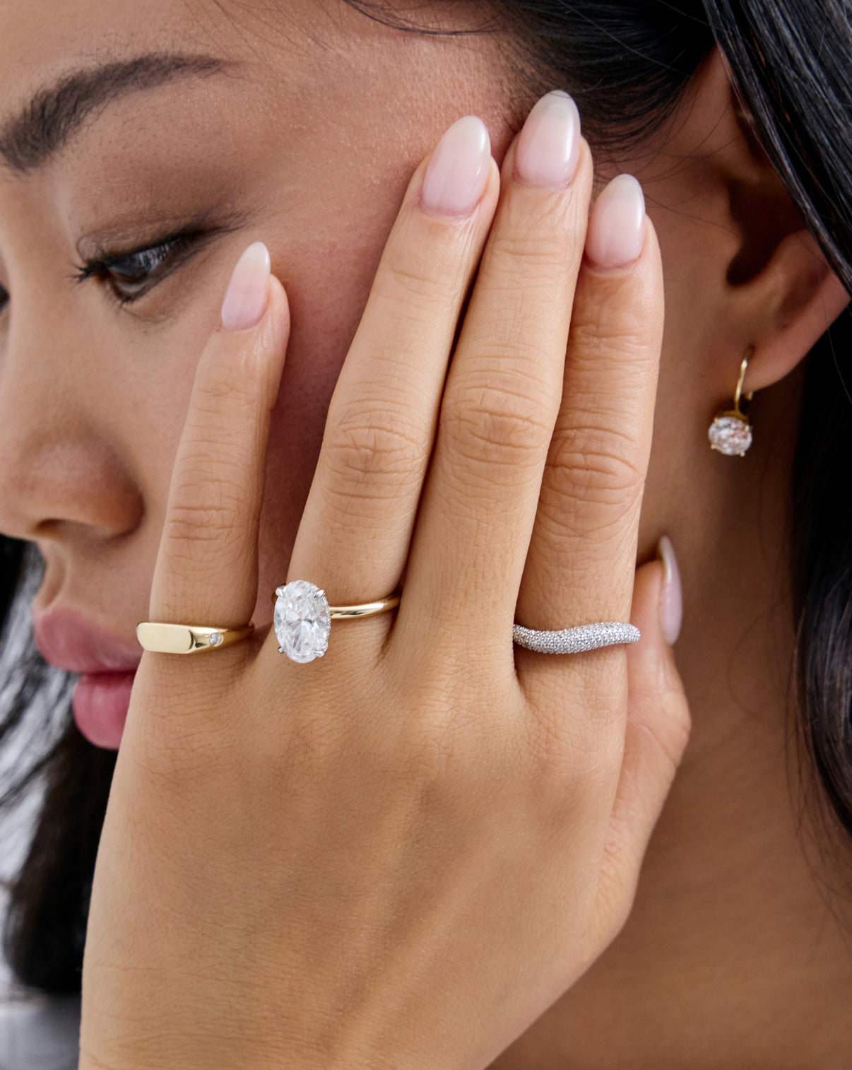Petite Pave Movement Cloud Ring styled on model's index finger with a diamond engagement ring and open diamond wrap ring
14k yellow gold 14k white gold