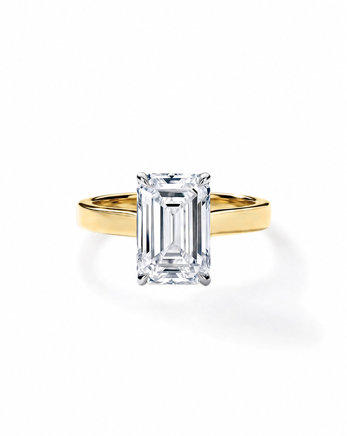 14k Yellow gold engagement ring with an emerald diamond in a four-prong setting, on a cigar-style band, shown on a white background. 44830089281624