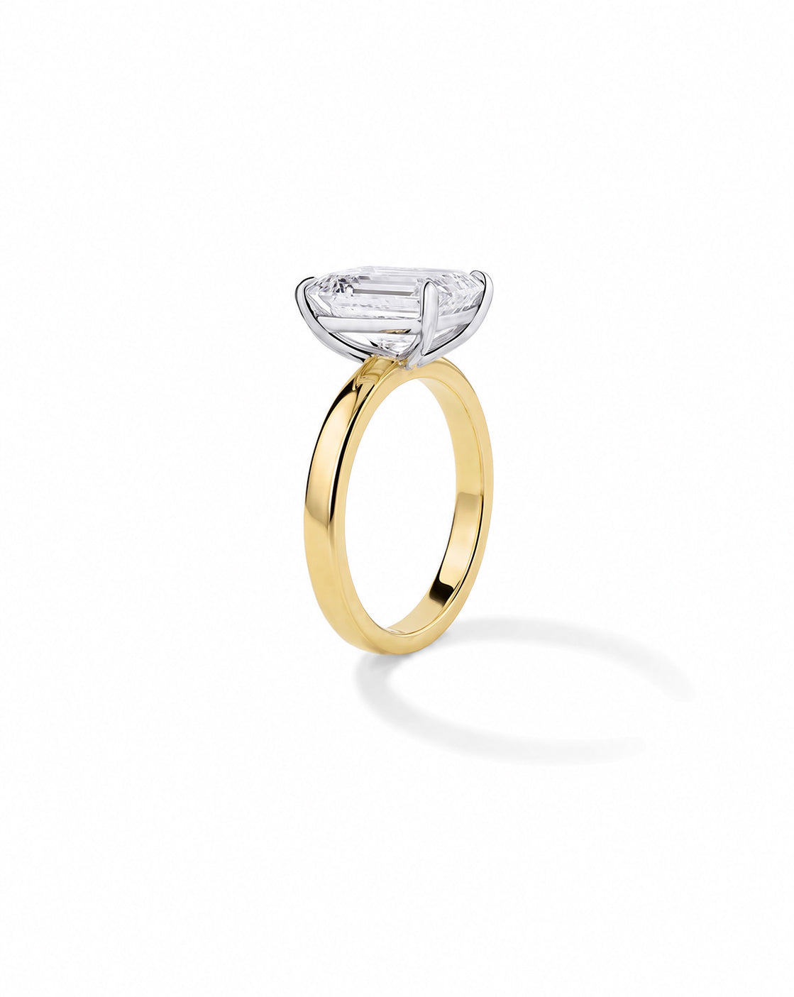 14k Yellow gold engagement ring with an emerald diamond in a four-prong setting, on a cigar-style band, shown on a white background. 44830089281624