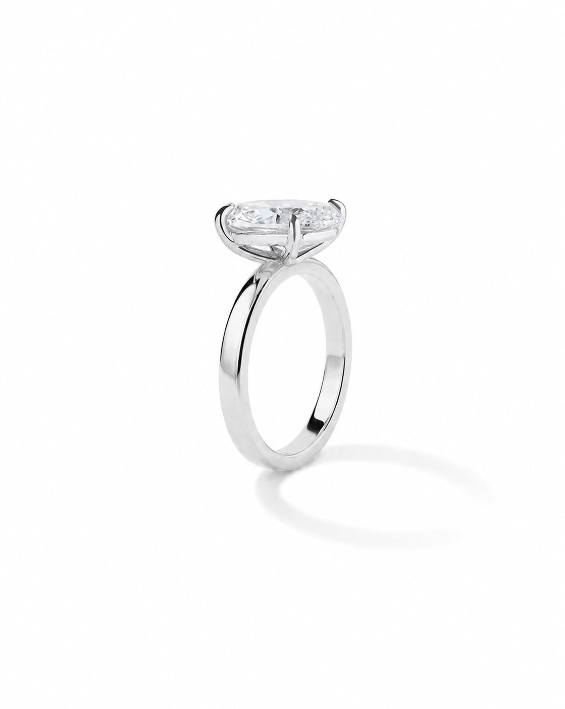 Platinum engagement ring with a round diamond in a white gold four-prong setting, on a cigar-style band, shown on a white background. 44830239129688 