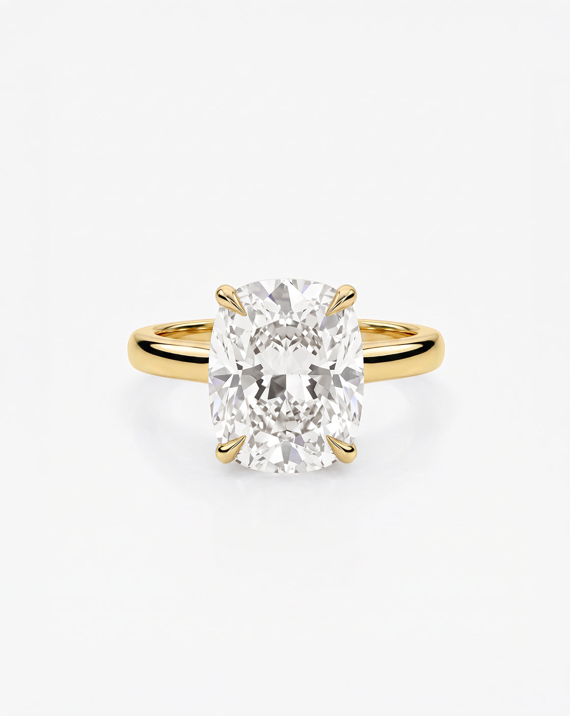 4.05 carat cushion cut lab-grown diamond engagement ring in a cathedral-style setting with 14K yellow gold band and platinum prongs, front view on white background