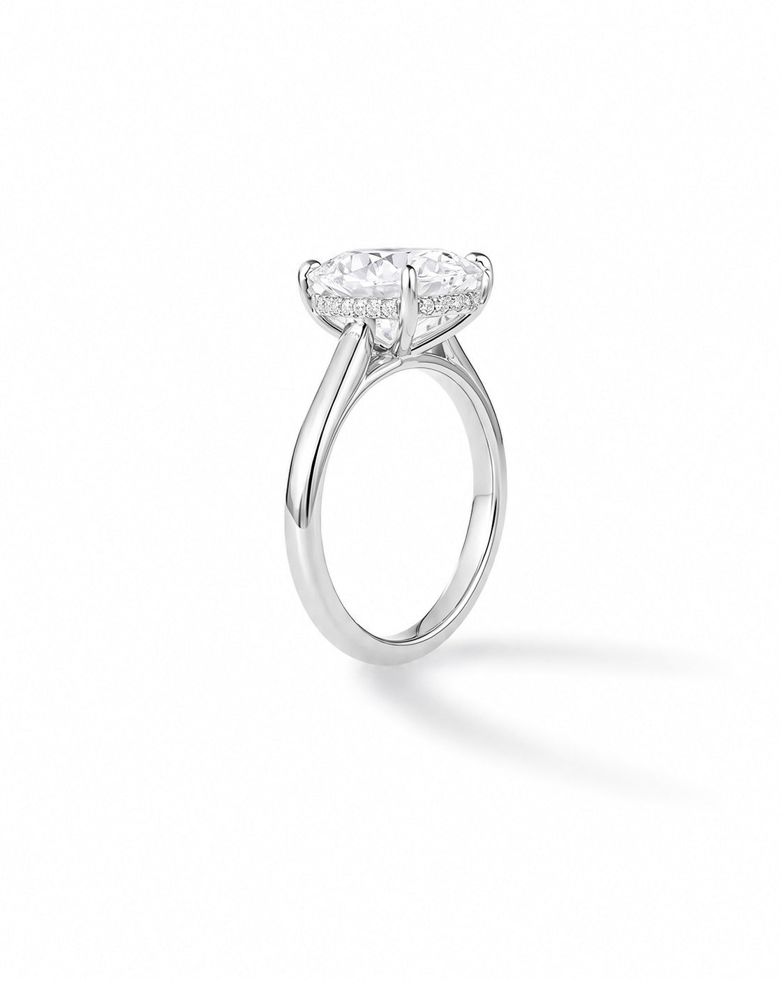 Platinum cathedral engagement ring with cushion-cut diamond and hidden halo, on white background 44836637900888