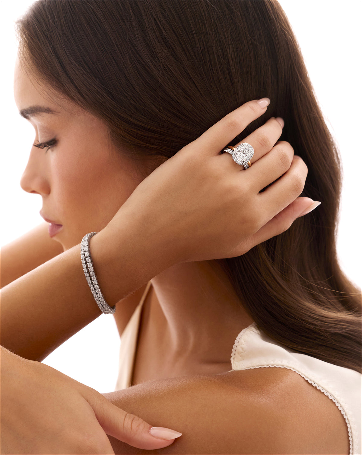 Cushion Cloud Bezel with Pavé Halo engagement ring shown on model with a tennis bracelet 44830239424600 44830239031384 44830238736472