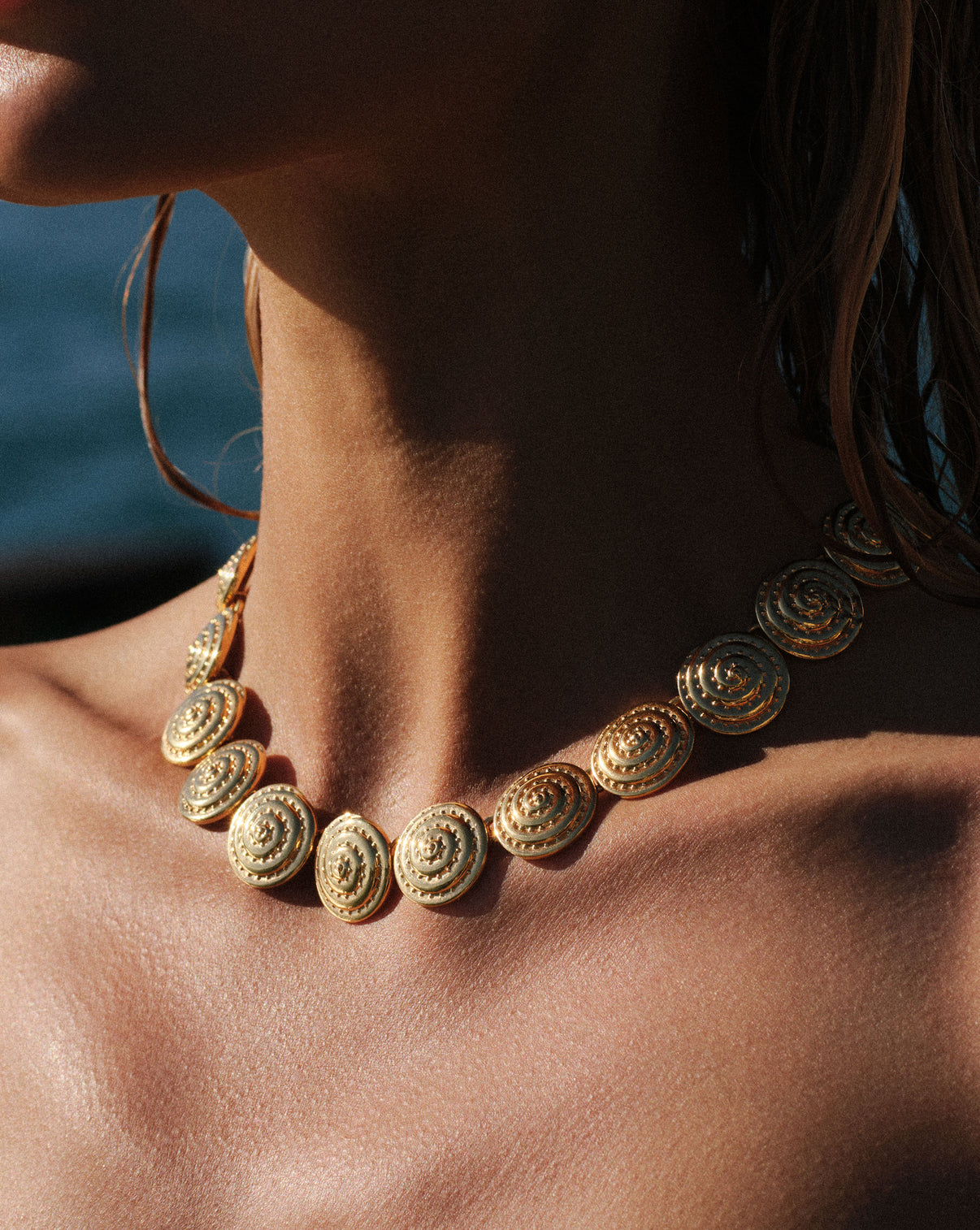 Sundial Necklace shown close up on model's neck