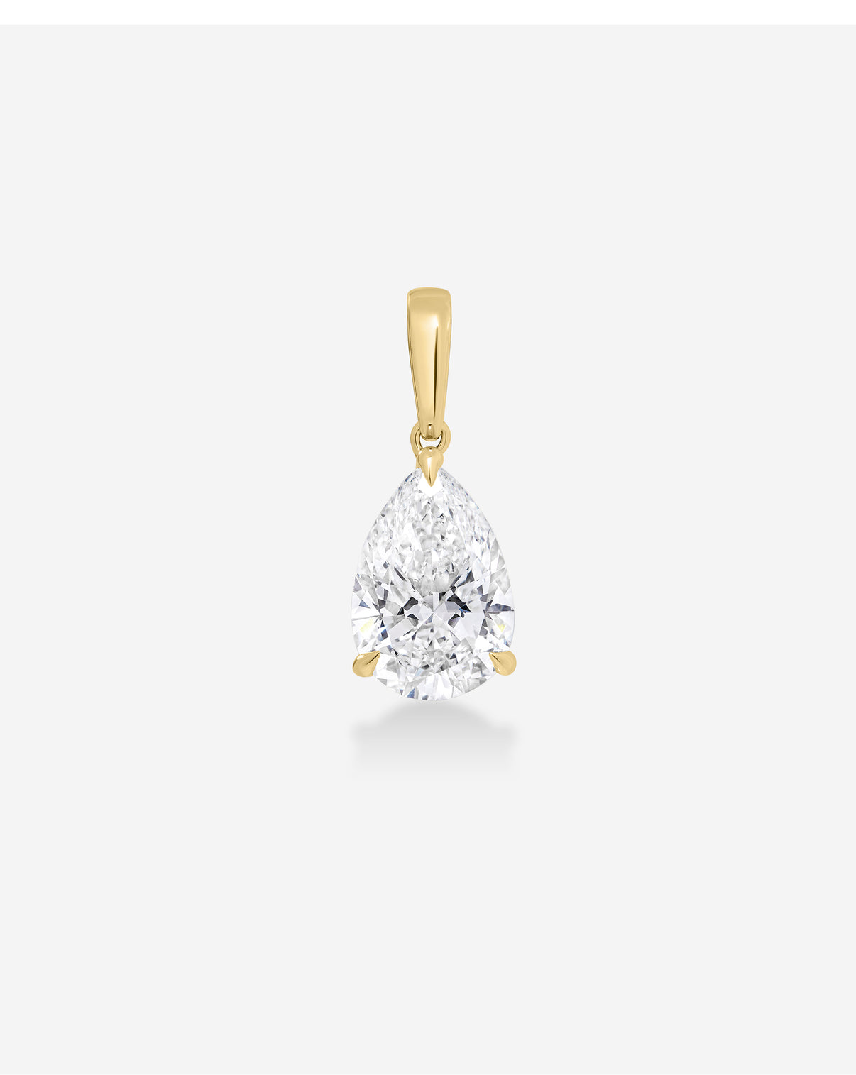A pear-cut diamond pendant in a yellow gold setting, suspended against a clean, light gray background.