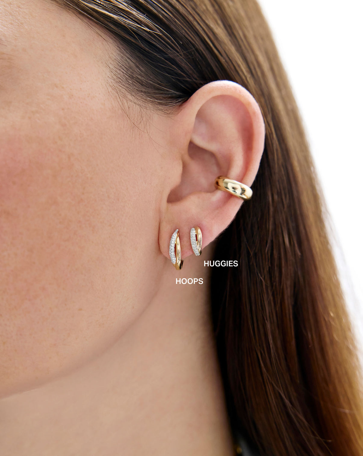 Close up view of model wearing the 14k solid gold Double Row Hoops paired with other earring styles GLOBAL