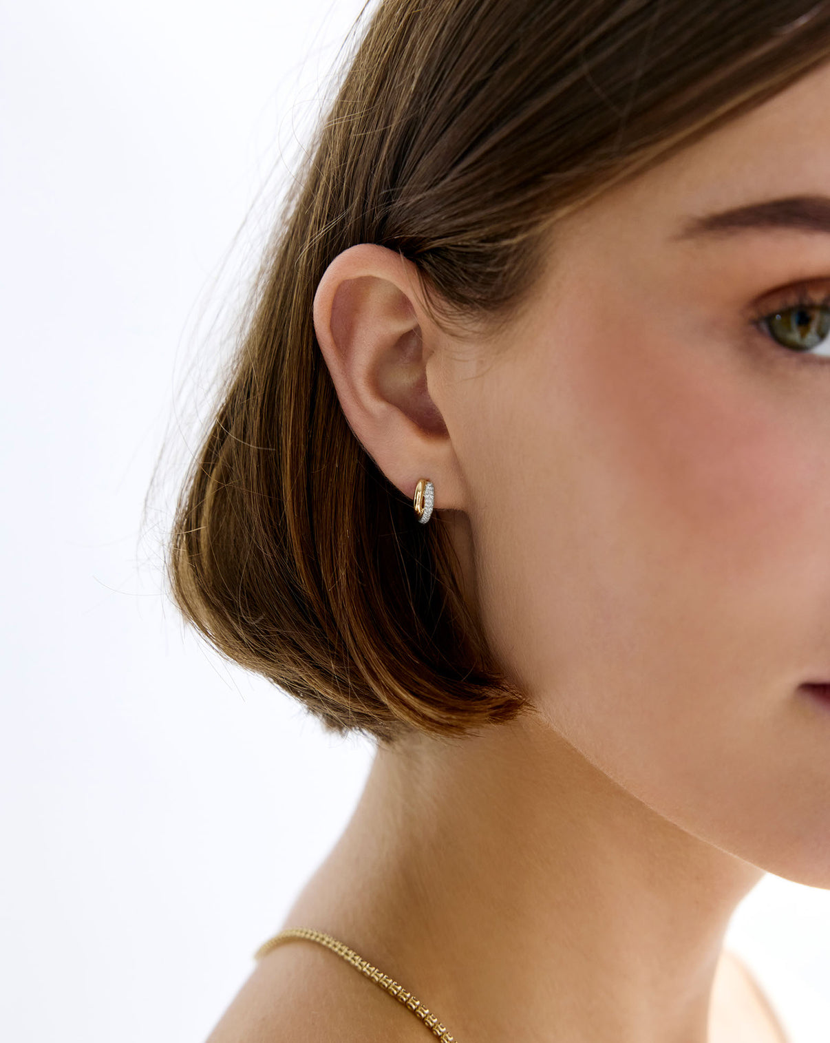 Close-up of Double Row Huggies worn on model's ear showing product details GLOBAL