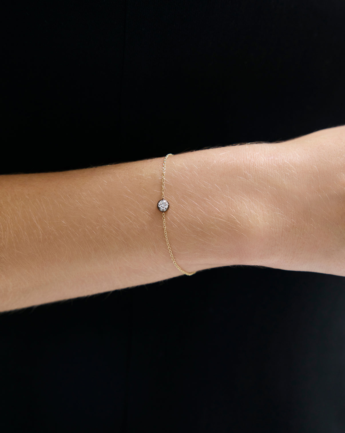 Detailed view of 14k gold Georgian lab diamond bracelet worn on arm showing diamond and gold chain