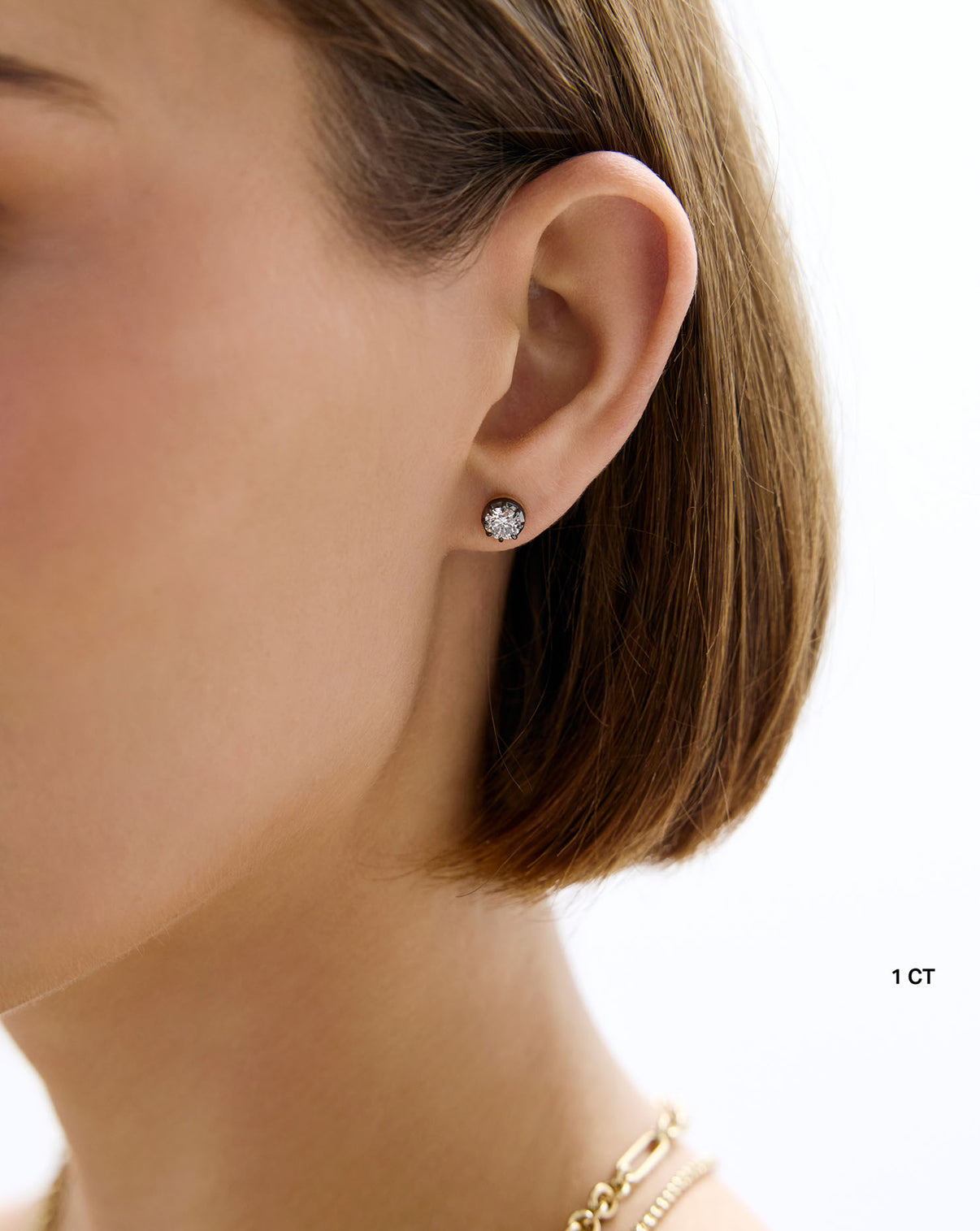 Close-up of Georgian lab diamond studs worn on ear Global