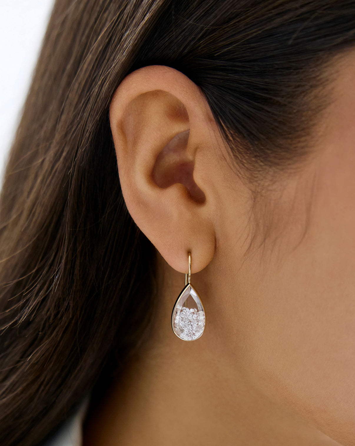 Close up view of model wearing Shaker Pear Drop Earring.