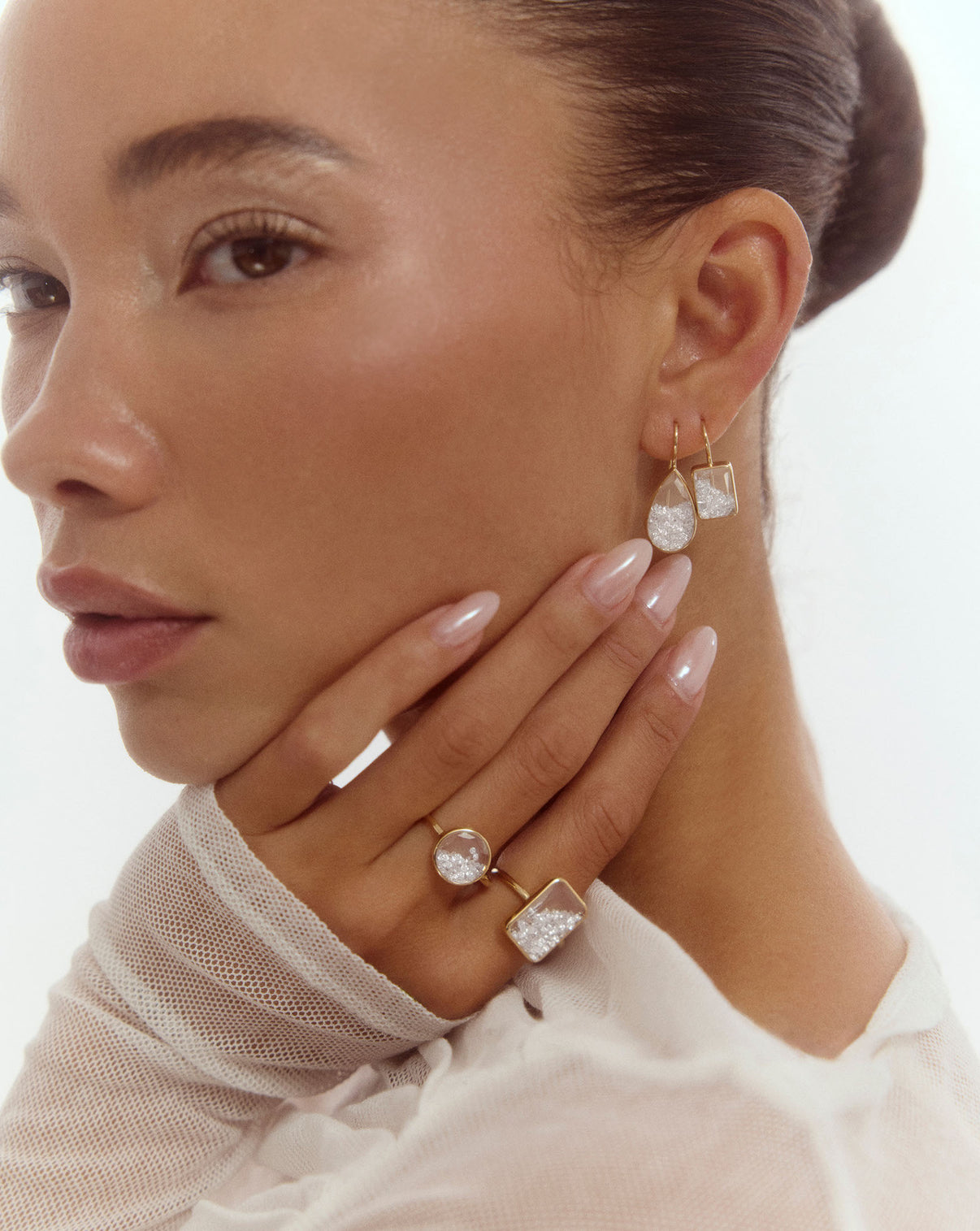 Model wearing our Shaker Pear Drop Earrings along with our Shaker Emerald Drop Earrings, Shaker Round Ring, and Shaker Emerald Ring.