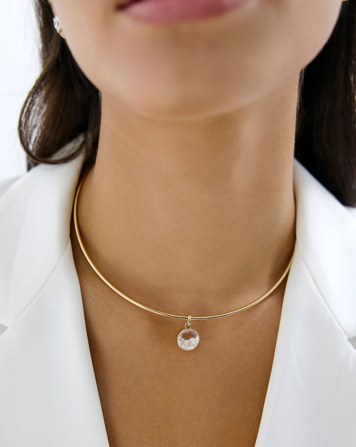 Model wearing our Shaker Round Pendant on gold necklace.