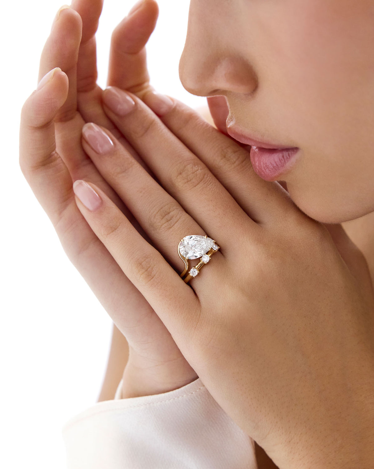 Model wearing Natural Diamond Trio Wedding Band stacked with pear diamond ring GLOBAL